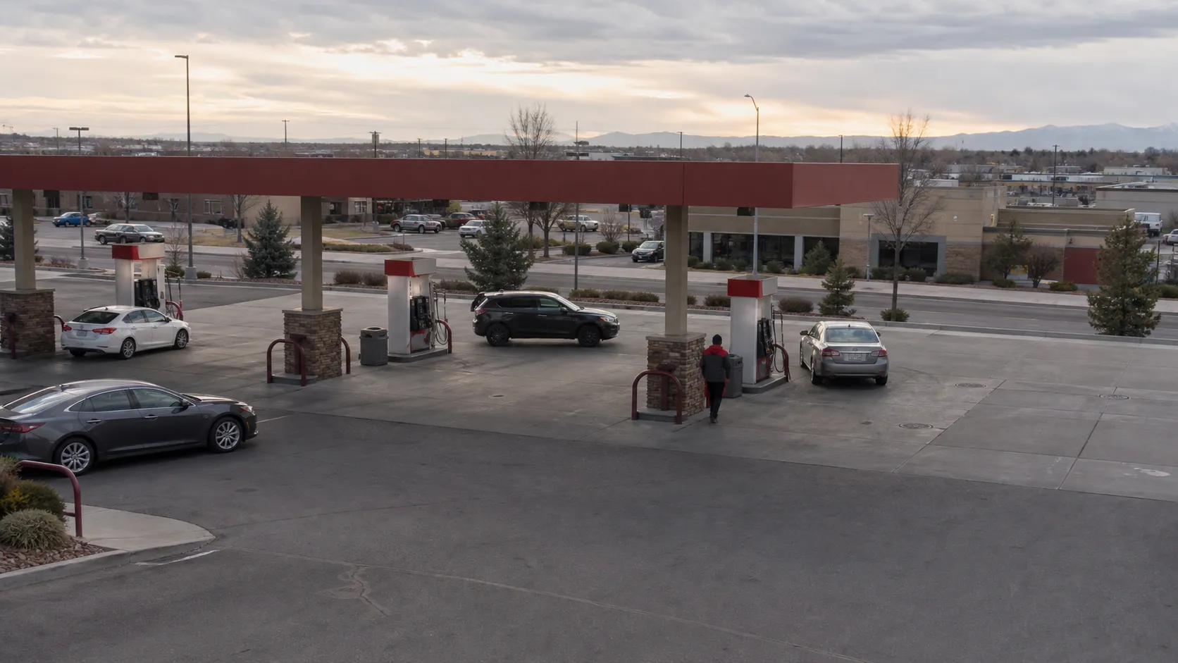 An operating fuel retail site with several pump islands and the surrounding commercial area